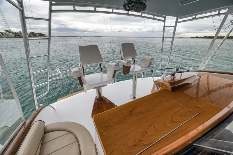 Slide: The Image of Luxury Merritt 58 yacht deck with seating, overlooking serene ocean waters, 1997 model. - 117