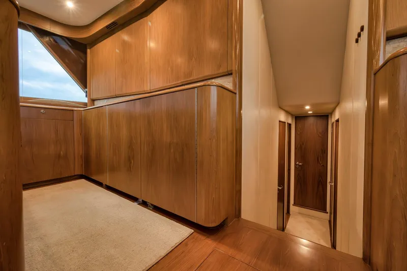 Slide: The Image of Luxurious wooden interior of a 1997 Merritt 58 yacht, featuring elegant cabinetry and hallway. - 128