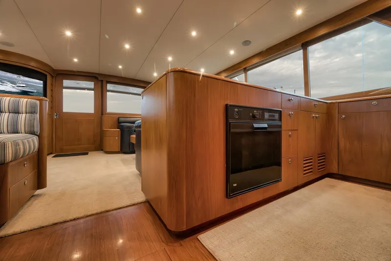 Slide: The Image of Luxurious interior of a 1997 Merritt 58 yacht with wood finishes and modern lighting. - 129