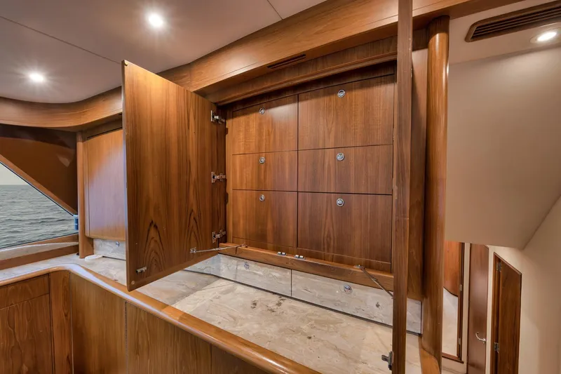 Slide: The Image of Luxurious wooden interior of 1997 Merritt 58 yacht with open cabinets. - 134