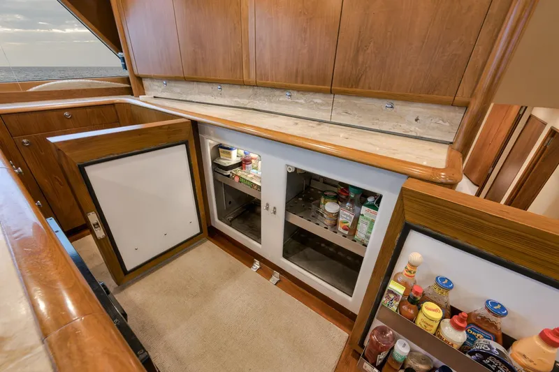Slide: The Image of Luxurious Merritt 58 yacht interior with open cabinets, showcasing ample storage space, 1997 model. - 135