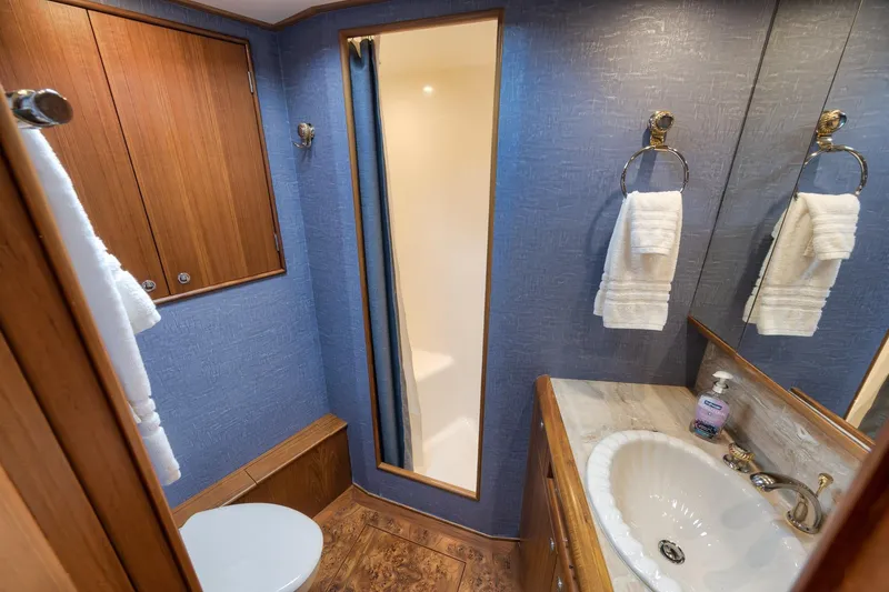 Slide: The Image of Luxurious bathroom in 1997 Merritt 58 yacht with wood accents and modern fixtures. - 142