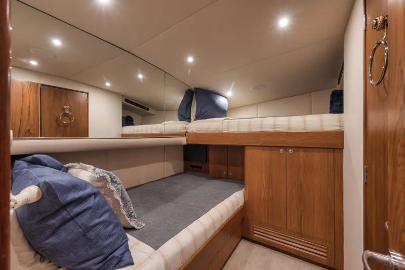 Slide: The Image of Luxurious cabin interior of 1997 Merritt 58 yacht with wooden accents and cozy bedding. - 145