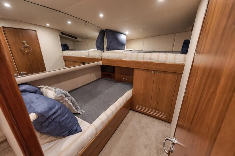 Slide: The Image of Luxurious cabin interior of a 1997 Merritt 58 yacht with wooden finishes and cozy bedding. - 146