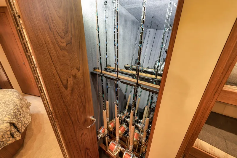 Slide: The Image of Fishing rods stored in a wooden cabinet on a 1997 Merritt 58 yacht. - 150