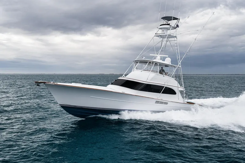 Slide: The Image of Luxury Merritt 58 yacht cruising on open sea under cloudy skies, 1997 model. - 21