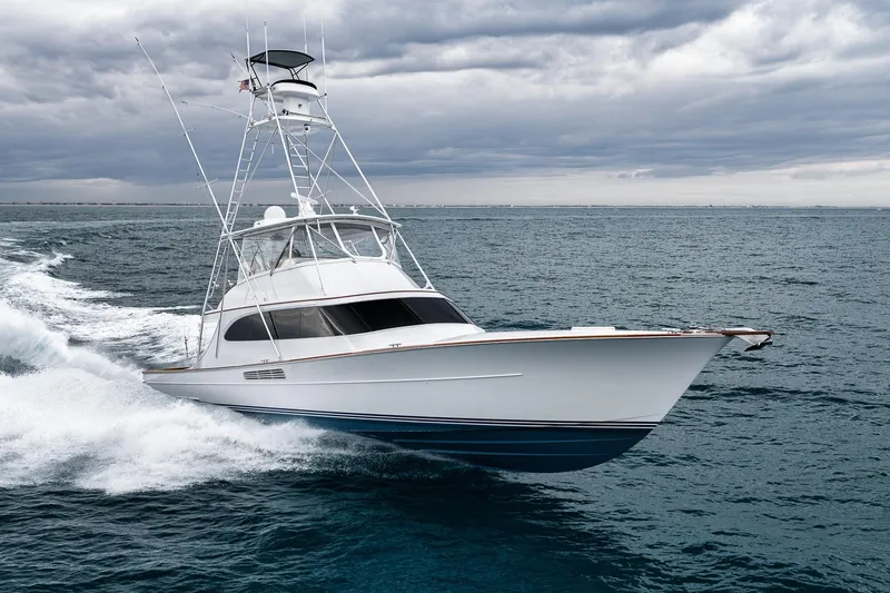 Slide: The Image of 1997 Merritt 58 yacht cruising on open sea under cloudy skies. - 24