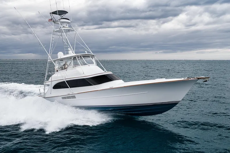 Slide: The Image of 1997 Merritt 58 yacht cruising on open sea under cloudy skies. - 25