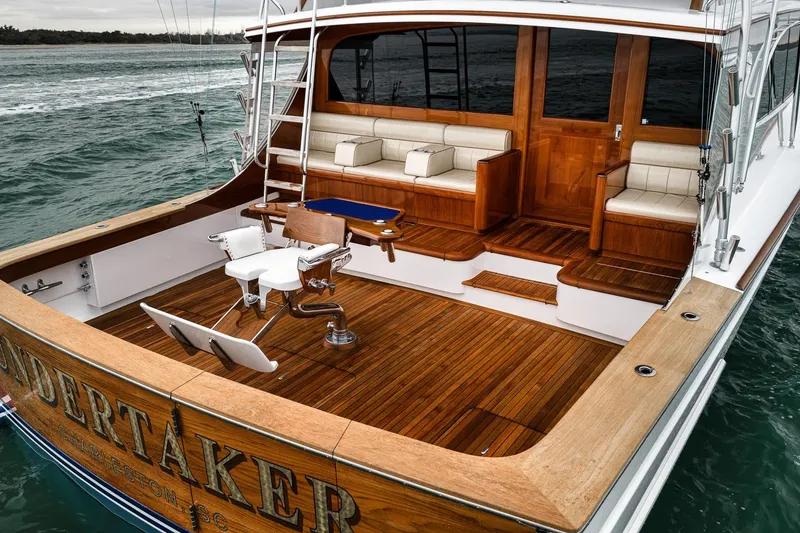 Slide: The Image of Luxurious 1997 Merritt 58 yacht with elegant wooden deck and seating area. - 34