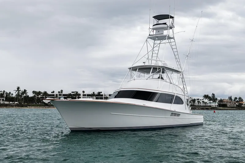 Slide: The Image of Luxury Merritt 58 yacht from 1997 on calm waters, with coastal backdrop. - 40