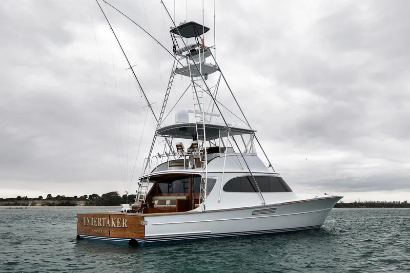 Slide: The Image of Luxury Merritt 58 yacht from 1997 on calm waters under cloudy skies. - 42