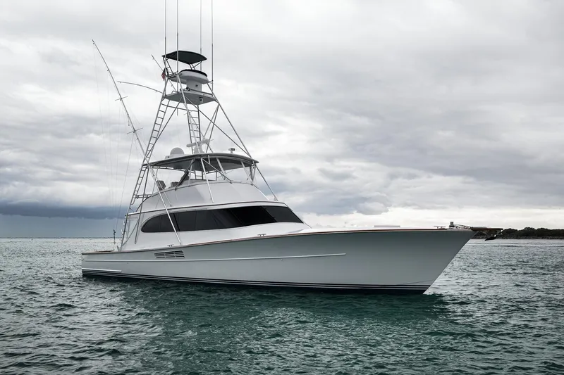 Slide: The Image of Luxurious 1997 Merritt 58 yacht on calm waters under cloudy skies. - 44