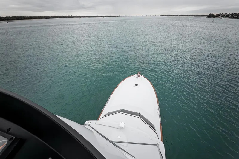 Slide: The Image of Bow view of 1997 Merritt 58 yacht on calm waters under cloudy skies. - 46
