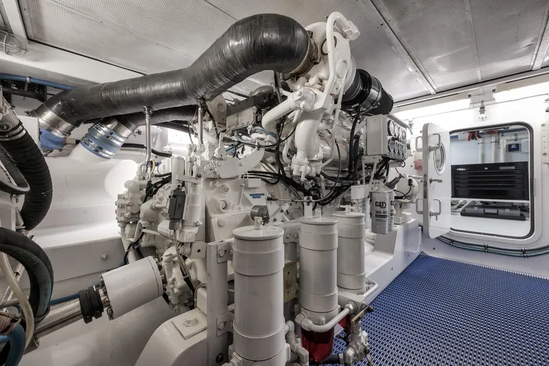 Slide: The Image of Engine room of a 1997 Merritt 58 yacht, featuring complex machinery and equipment. - 56