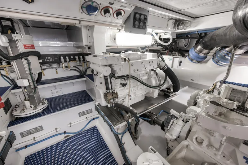 Slide: The Image of Engine room of a 1997 Merritt 58 yacht, showcasing machinery and fuel gauges. - 58