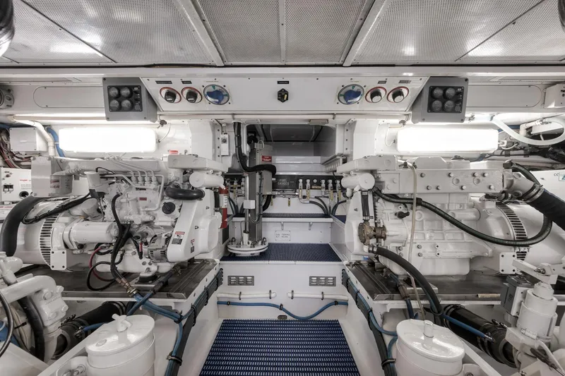 Slide: The Image of Engine room of a 1997 Merritt 58 yacht, featuring dual engines and control panels. - 59