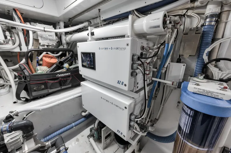Slide: The Image of Engine room of a 1997 Merritt 58 boat with water filtration system and tool bag. - 63