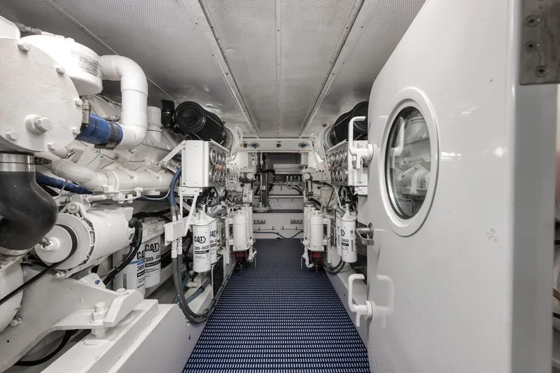 Slide: The Image of Engine room of a 1997 Merritt 58 yacht, featuring CAT machinery and equipment. - 64