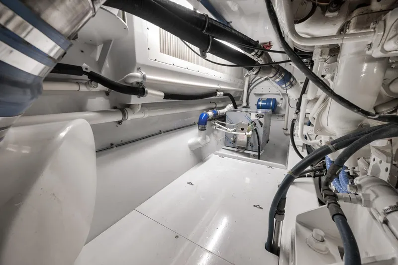 Slide: The Image of Engine room of a 1997 Merritt 58 yacht, showcasing pipes and machinery. - 65