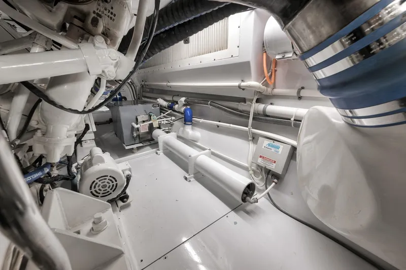 Slide: The Image of Engine room of a 1997 Merritt 58 yacht, showcasing mechanical components and piping. - 66