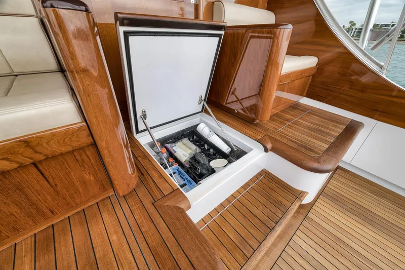 Slide: The Image of Luxurious 1997 Merritt 58 yacht interior with open storage compartment and elegant wood finish. - 68