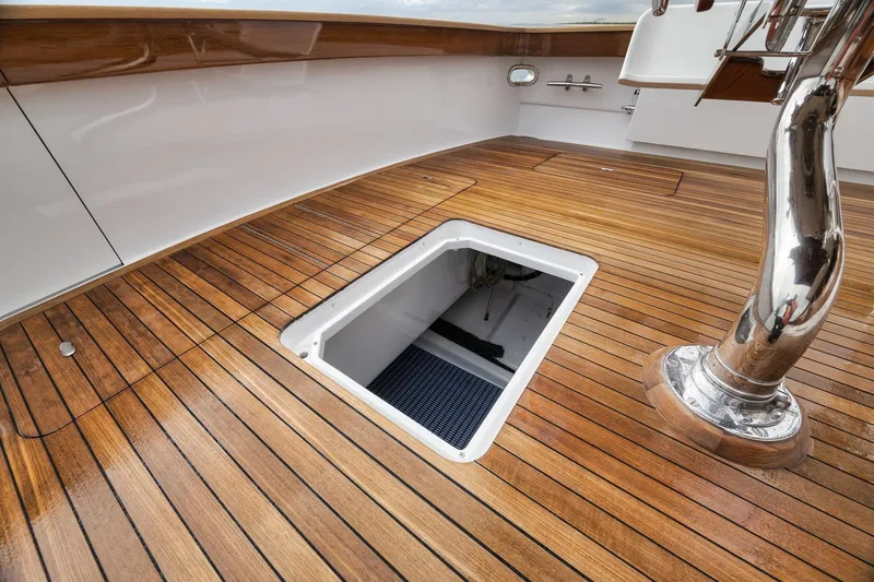Slide: The Image of Teak deck of 1997 Merritt 58 yacht with open hatch and polished metal fixture. - 74
