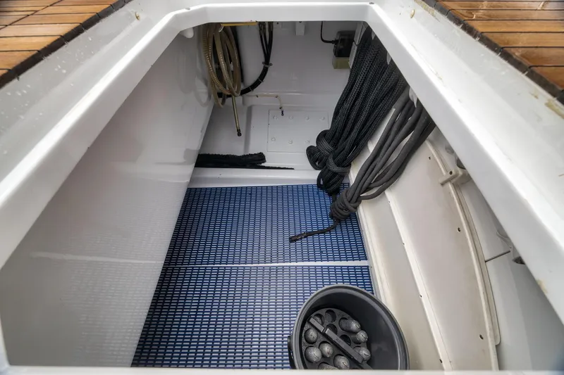Slide: The Image of Storage compartment on a 1997 Merritt 58 boat with ropes and equipment. - 77