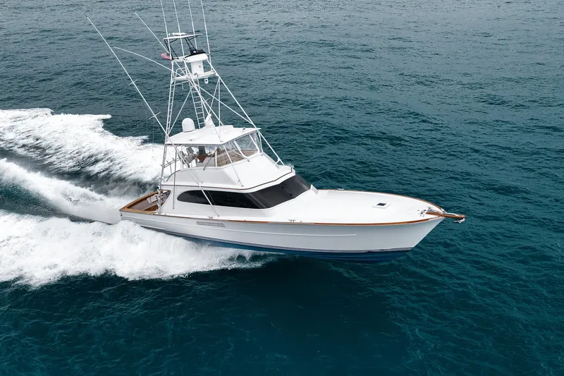 Slide: The Image of A 1997 Merritt 58 yacht cruising on open ocean waters. - 8