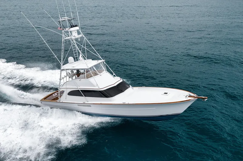 Slide: The Image of 1997 Merritt 58 yacht cruising on open ocean waters. - 9