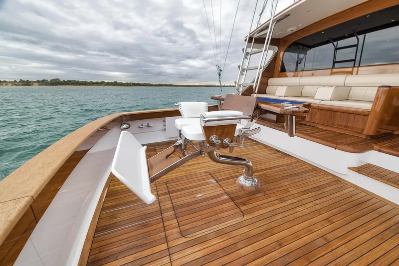 Slide: The Image of Luxurious 1997 Merritt 58 yacht deck with wooden flooring and comfortable seating. - 91