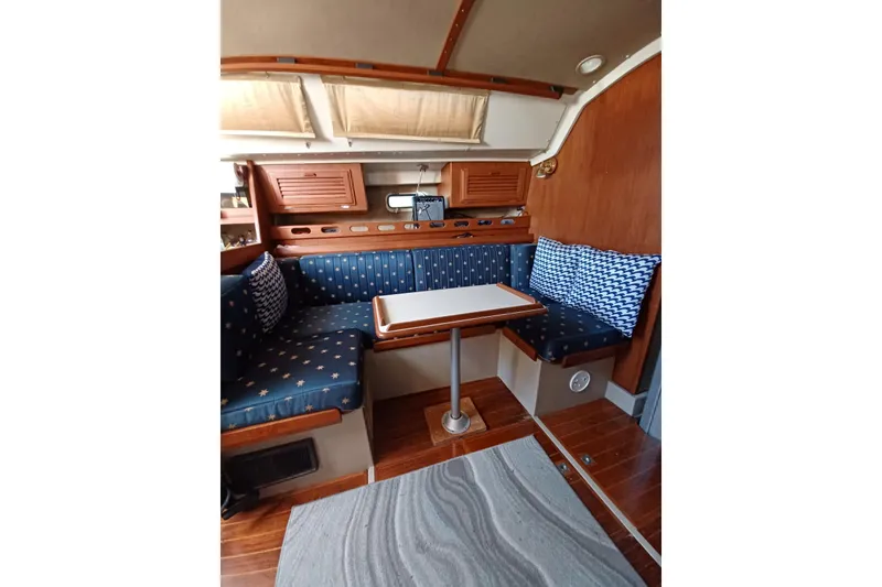 Slide: The Image of Interior of 1987 O'Day 40 sailboat with cozy seating and wooden accents. - 11