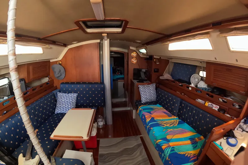 Slide: The Image of Interior of a 1987 O'Day 40 sailboat with cozy seating and vibrant decor. - 13