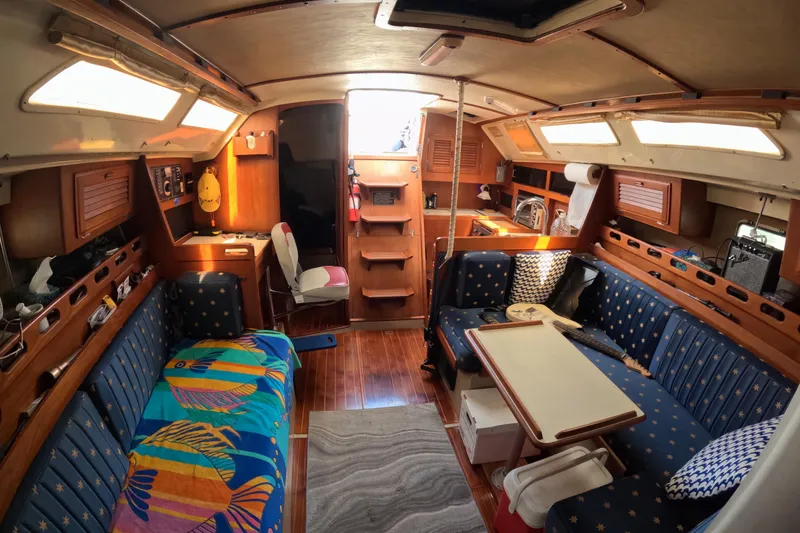 Slide: The Image of Interior of a 1987 O'Day 40 sailboat with cozy seating and vibrant decor. - 14