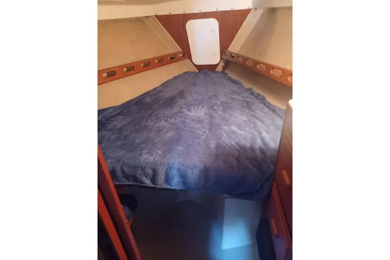 Slide: The Image of Cozy cabin interior of 1987 O'Day 40 sailboat with blue bedding. - 15