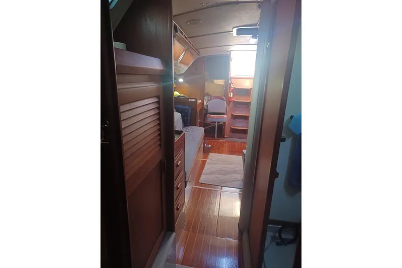 Slide: The Image of Interior of 1987 O'Day 40 sailboat with wooden flooring and cozy cabin space. - 16