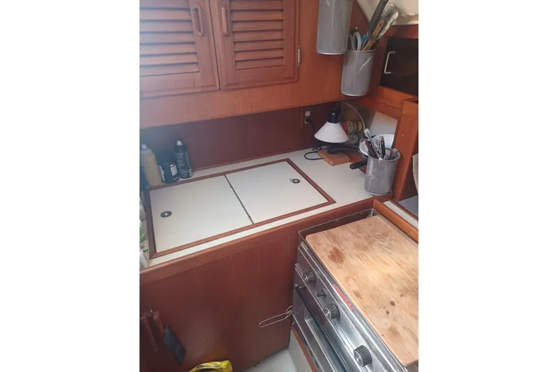 Slide: The Image of 1987 O'Day 40 yacht kitchen with wooden cabinets and stove. - 18