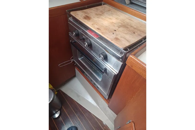 Slide: The Image of 1987 O'Day 40 yacht kitchen with stainless steel oven and wooden countertop. - 19