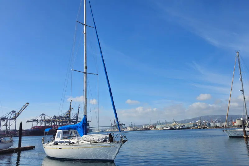 Slide: The Image of 1987 O'Day 40 sailboat docked in a busy harbor under a clear blue sky. - 2
