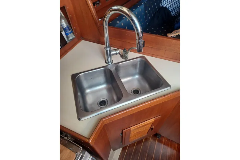 Slide: The Image of Double sink in 1987 O'Day 40 yacht galley with wooden cabinetry. - 20
