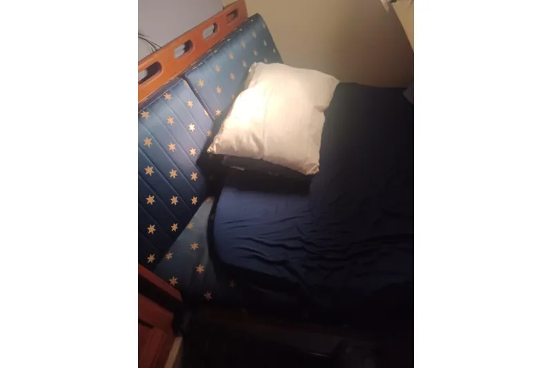 Slide: The Image of Cozy cabin bed with star-patterned upholstery in 1987 O'Day 40 sailboat. - 21