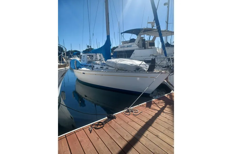 Slide: The Image of 1987 O'Day 40 sailboat docked at marina under clear blue sky. - 5