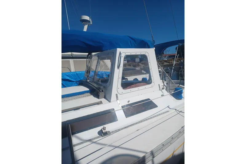 Slide: The Image of 1987 O'Day 40 sailboat with blue canopy and clear cockpit enclosure. - 6