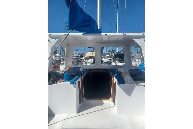 Slide: The Image of 1987 O'Day 40 sailboat cockpit with blue sail cover, marina background. - 8