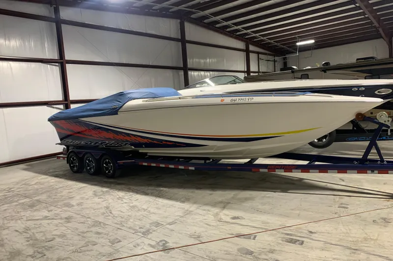 The Image of 2008 Sunsation 32 Mid-Cabin boat on trailer in indoor storage facility. - 1