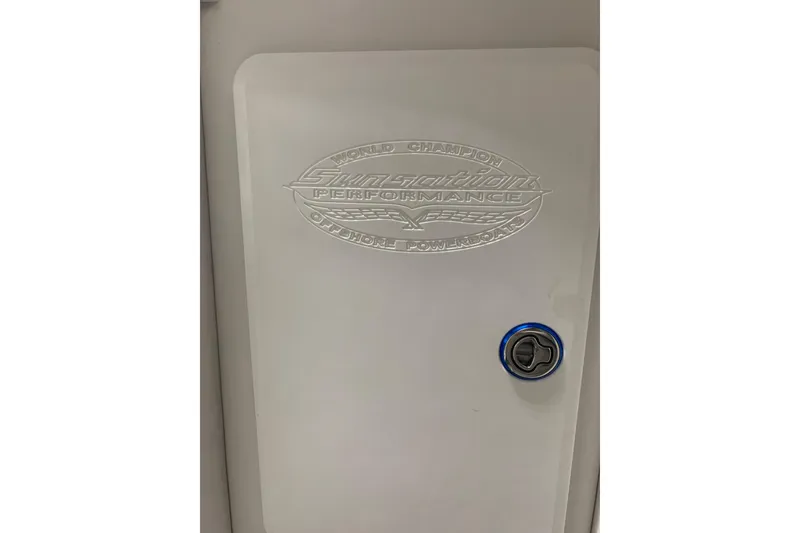 Slide: The Image of 2008 Sunsation 32 Mid-Cabin boat door with embossed logo and blue-accented handle. - 10