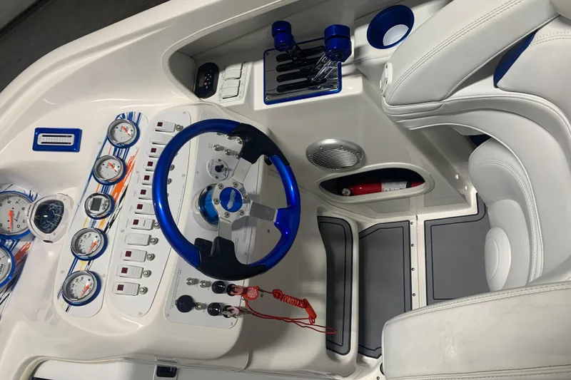 Slide: The Image of 2008 Sunsation 32 Mid-Cabin boat cockpit with blue accents and detailed gauges. - 4