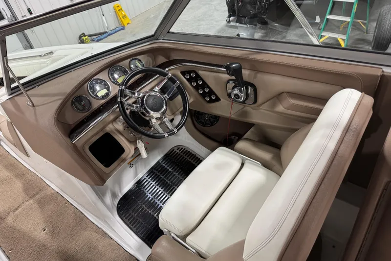 Slide: The Image of Interior of a 2012 Cobalt 276 boat showing steering wheel and dashboard controls. - 10