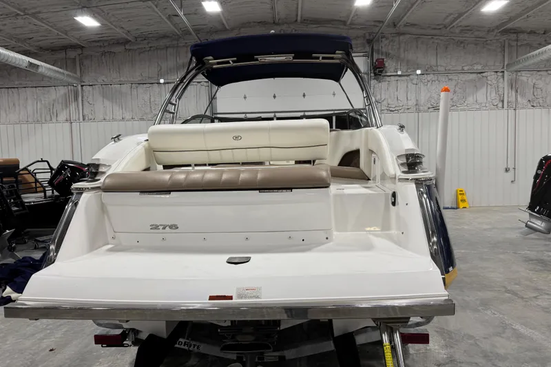 Slide: The Image of 2012 Cobalt 276 boat in a warehouse, rear view with seating and storage. - 5