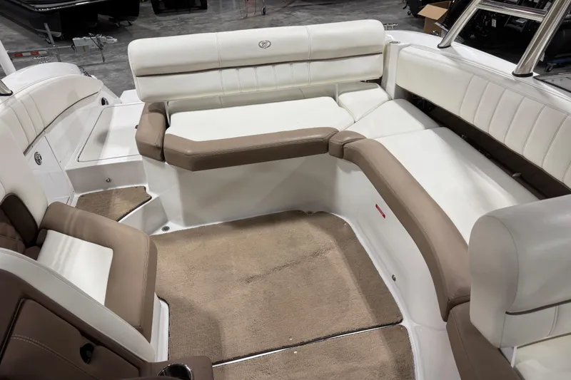 Slide: The Image of Interior of a 2012 Cobalt 276 boat with beige and white seating. - 7
