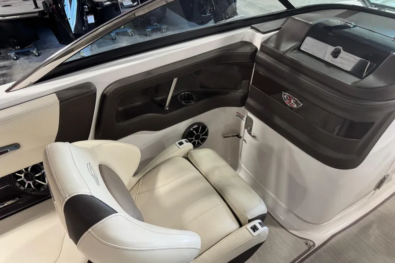 Slide: The Image of 2019 Chaparral 257 SSX boat interior with luxurious seating and sleek dashboard design. - 10